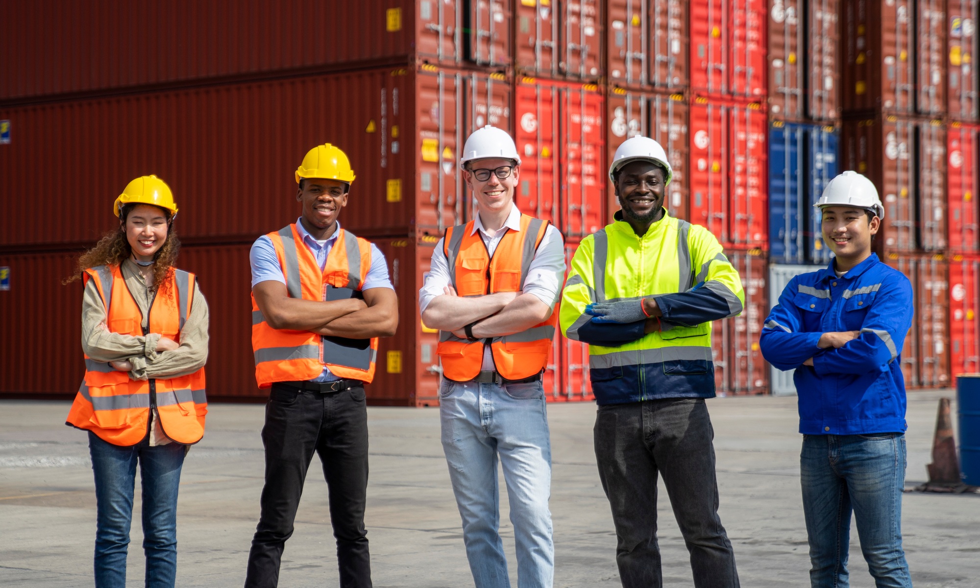Group of engineer worker and manager standing in the shipping yard container.