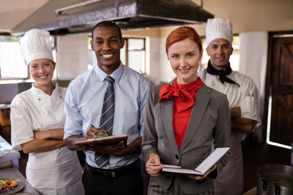 Group of hotel staffs standing in kitchen